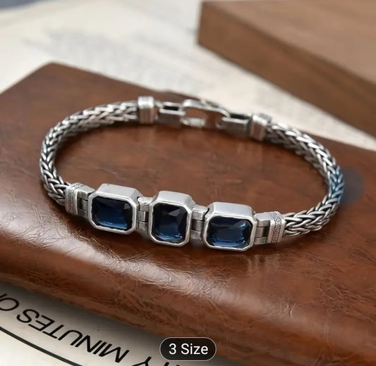 Handwoven braided male bracelet with sapphire blue gemstone