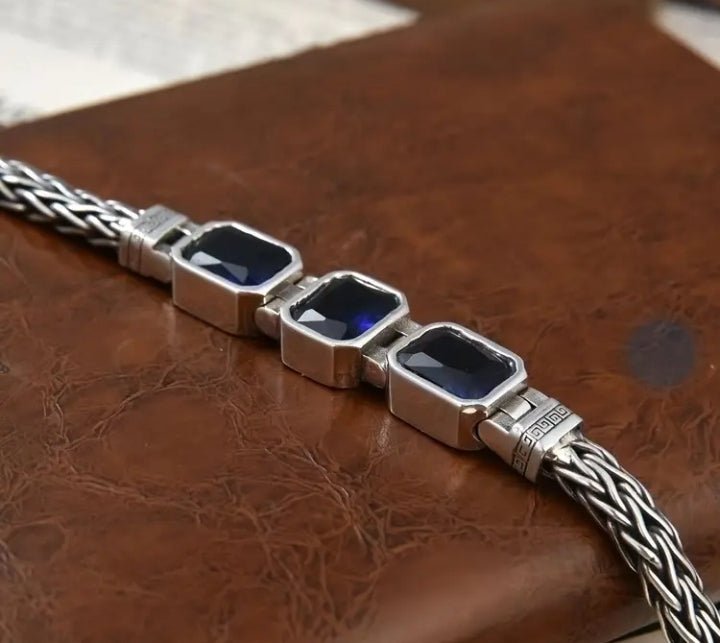 Handwoven braided male bracelet with sapphire blue gemstone