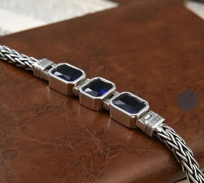 Handwoven braided male bracelet with sapphire blue gemstone